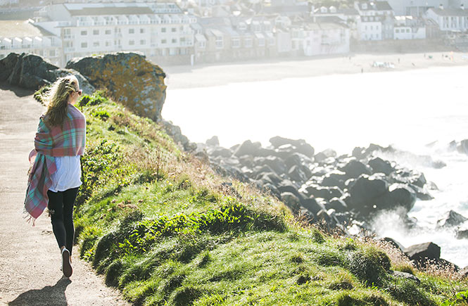 A woman walking on the cliffs above St Ives