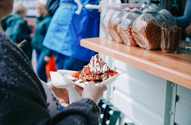 A waffle topped with fresh fruit and whipped cream at the Porthleven Food Festival