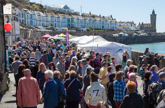 People walking along the stalls at the Porthleven Food Festival