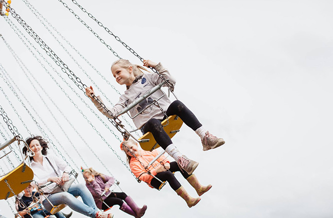 Children flying around on the chair-o-plane at Royal Cornwall Show fun fair
