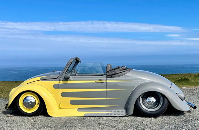 A yellow and grey VW car on the cliffs at Newquay for Run to the Sun