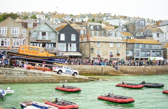 St Ives harbour on Lifeboat Day with the lifeboat pulled up the slipway and smaller lifeboats in the harbour