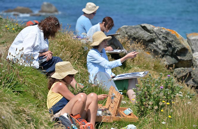 People painting on the cliffs around St Ives during the St Ives September Festival