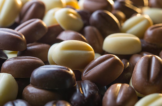 A pile of solid white, milk, and dark chocolate beans from Trenance Chocolate
