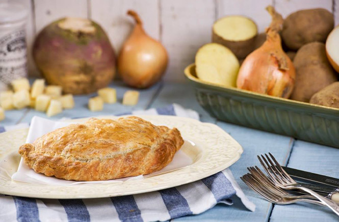 A Cornish pasty from Cornish Oven on a plate surrounded by its ingredients
