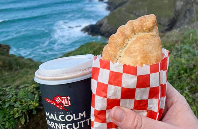 A Cornish pasty and takeaway coffee from Malcom Barnecutt being enjoyed on the Cornish cliffs