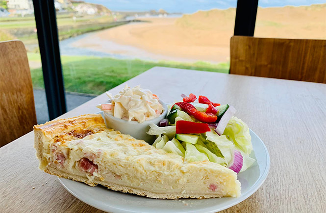 A plate of quiche and salad overlooking Bude canal from Cafe Limelight at The Castle