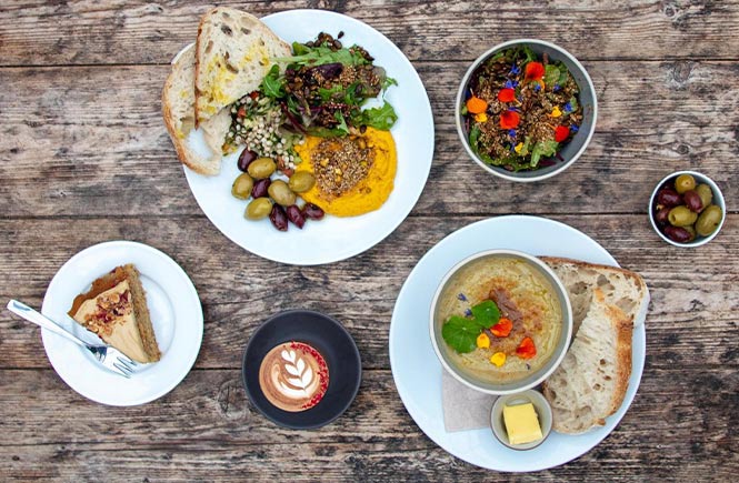 An array of vegan dishes and cakes at Potager Garden, one of the best vegan and vegetarian restaurants in Cornwall