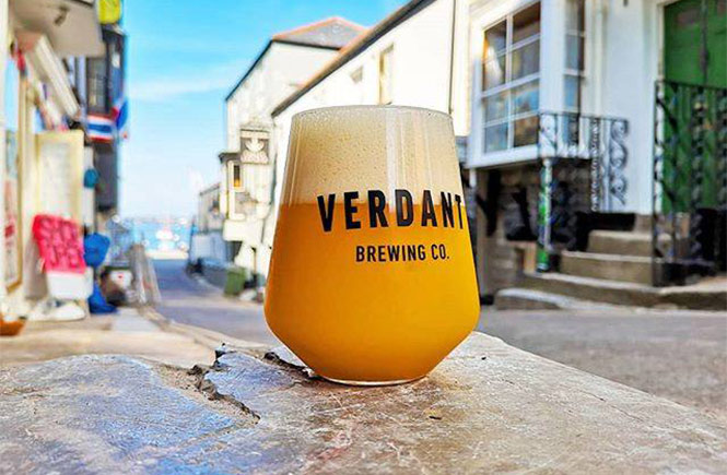 A glass of Verdant beer with the streets of Falmouth behind at Verdant Seafood Bar