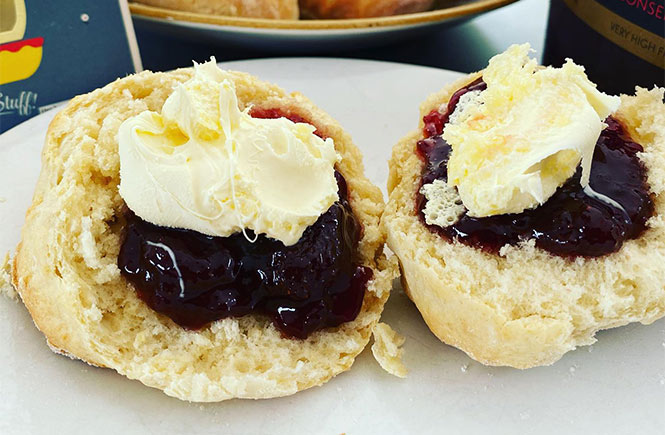 Two scones topped with clotted cream and jam at Godrevy Café