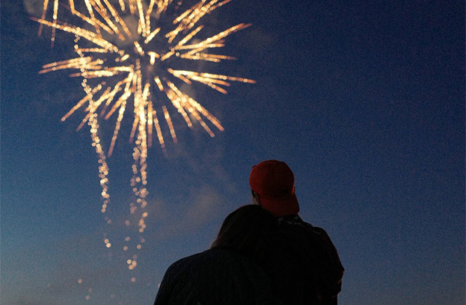 A couple watching the fireworks in Newquay from The Atlantic Hotel