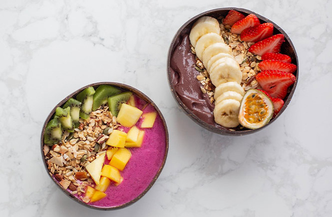 Two brightly coloured smoothie bowls at Box and Barber in Newquay