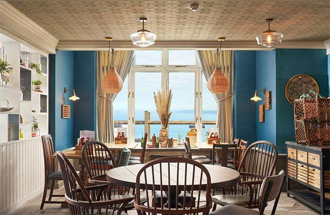 The beautiful dining room with views across the sea at The Fort Inn, a dog-friendly pub in Newquay