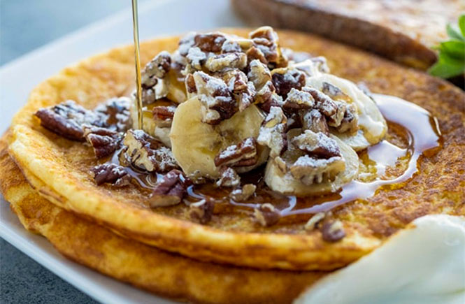 Pancakes with walnuts, banana and maple syrup at Count House Café