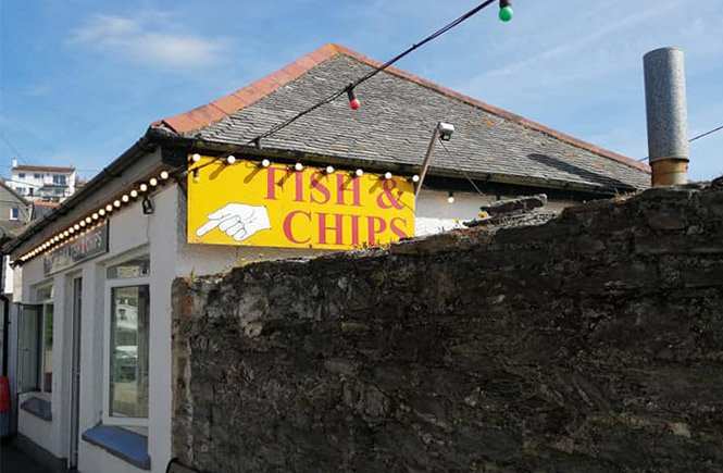 The big yellow fish and chips sign outside Porthleven Fish and Chips