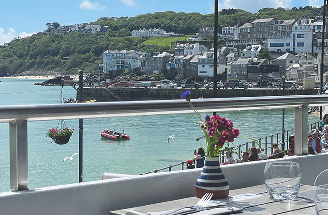 Looking out over the balcony of Portminster Kitchen at the beach and sea