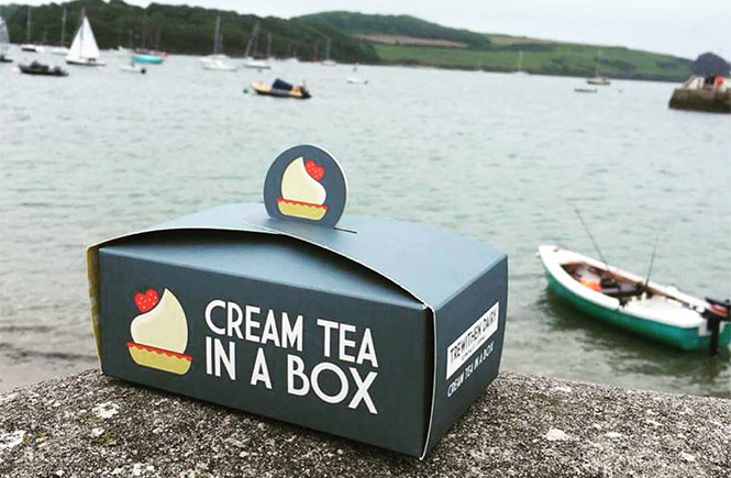 One of the cream tea boxes by Mr Scorse Gourmet Deli and Wines sitting on the harbour wall