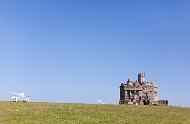 The granite form of Pendennis Castle surrounded by grass