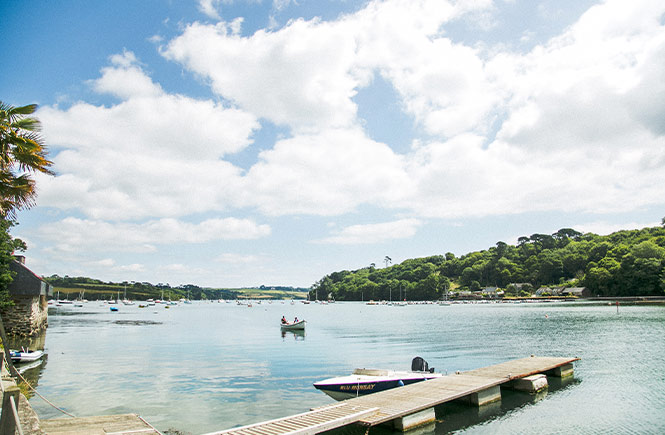 A pretty jetty surrounded by the pretty scenes of Helford River, one of the best places for a picnic in Cornwall