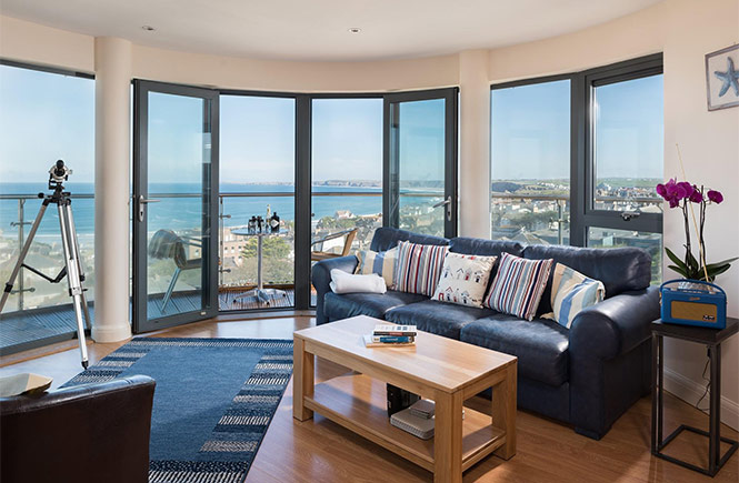 The stylish living room at 22 Horizons with sea views out across the coast in Newquay, perfect for storm-watching