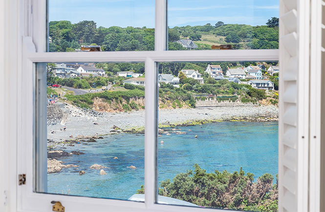 Looking out of the window at Gunvor Cottage at the beach and sea in Coverack