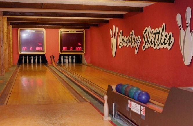 The skittles alley with bowling balls and score boards at Country Skittles