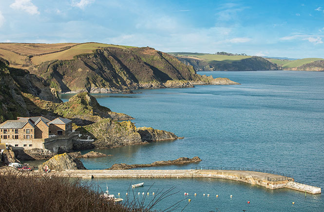 Looking down at the harbour at Mevagissey with the stretch of coastline and sea behind