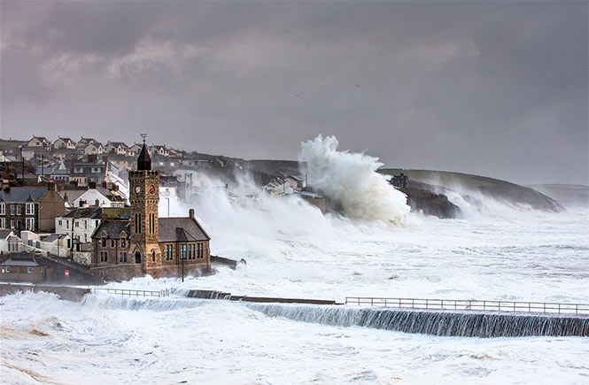 Giant waves crashing against Porthleven during a storm