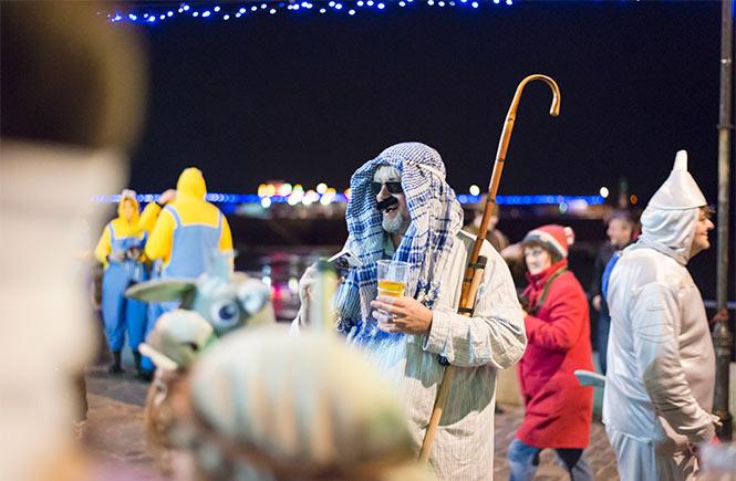 A group of people in fancy dress for New Year's Eve on St Ives harbour front