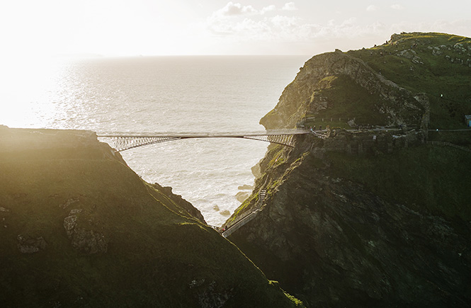 The incredible bridge at Tintagel on the South West Coast Path towering above the cliffS