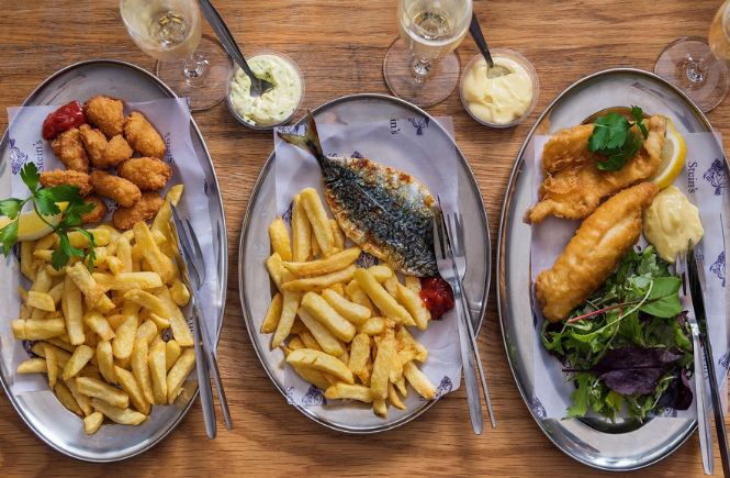 A plate of scampi and chips, pan fried fish and a battered fish at Rick Stein, Fistral