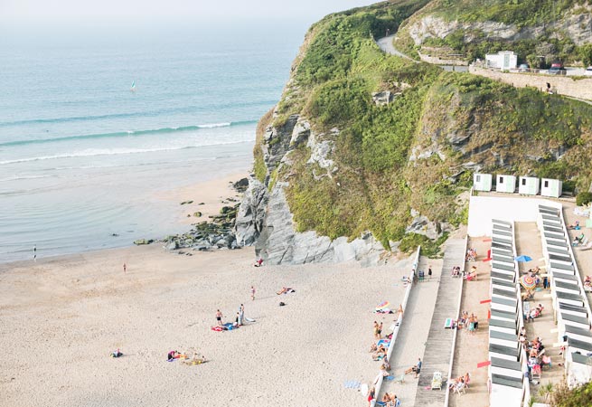 The beach and layered beach huts at Tolcarne beach