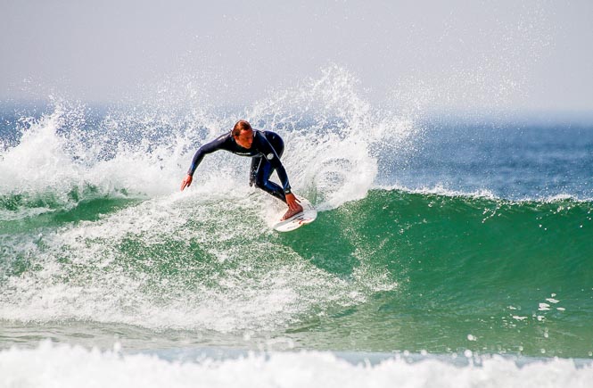 surfer at preaa sands, Cornwall