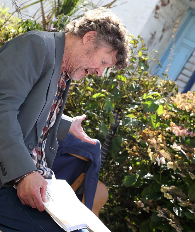 Man gesticulating while reading poetry in St Ives