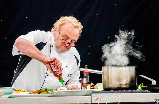 Chefs giving a demonstration on the Chefs Stage at the Porthleven Food Festival