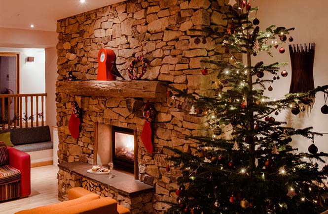 Christmas tree and fireplace that has been decorated