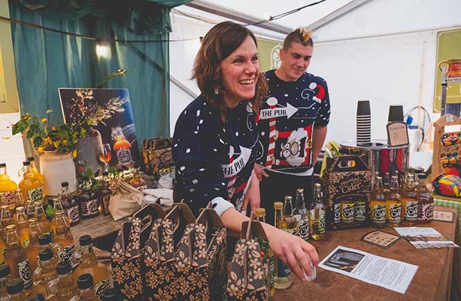 two traders selling cider at Fowey Christmas market