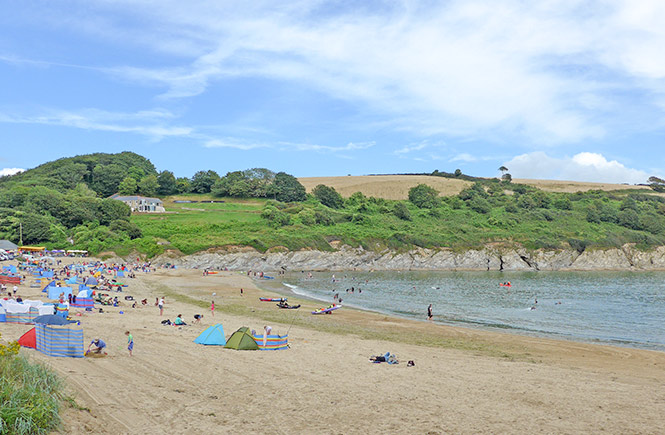Families playing on the beach at Maenporth