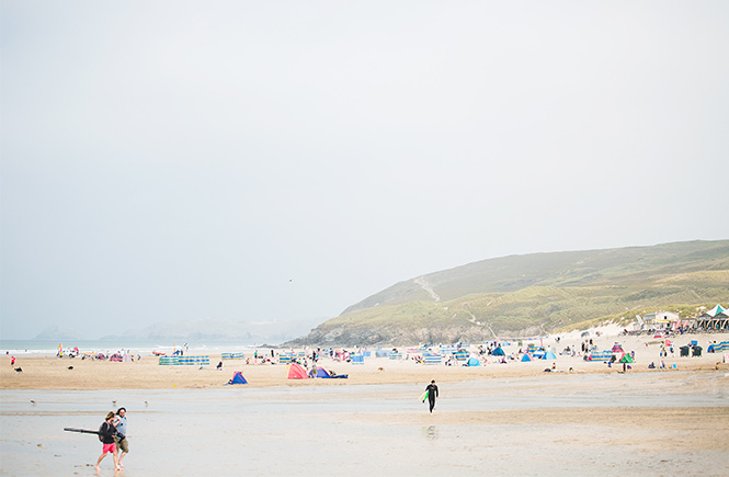 Surfers and beachgoers enjoying the spacious sands at Perranporth beach, one of the great dog-friendly beaches in Cornwall