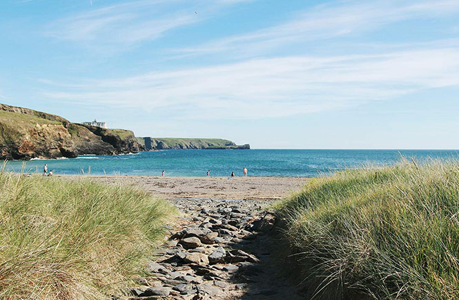 The turquoise waters and sandy beach at Poldhu on The Lizard