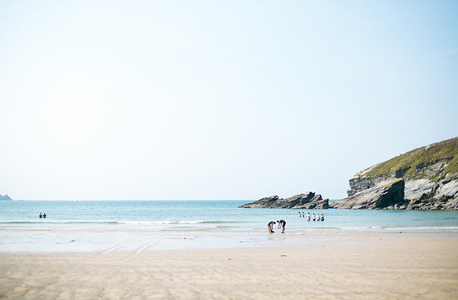 Looking out across the white sands at the sea at Porth beach in Newquay