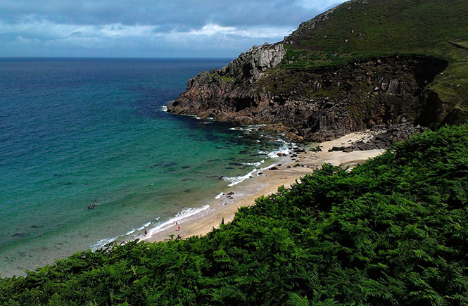 The secluded and dog-friendly Portheras Cove with its tall cliffs and blue sea