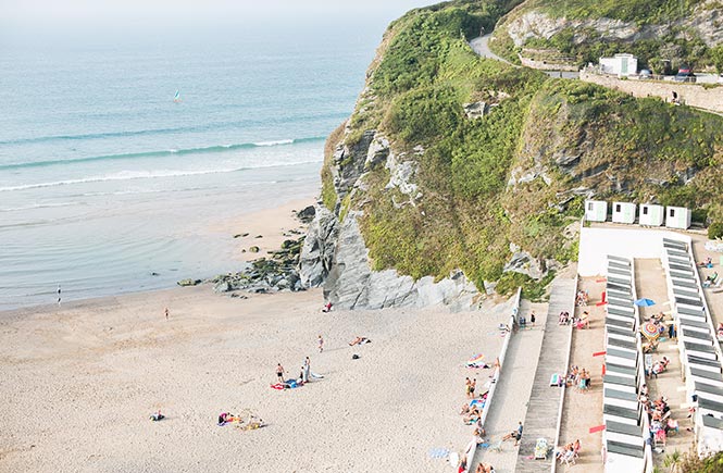 The clear waves, white sand and tiered platforms at Tolcarne beach