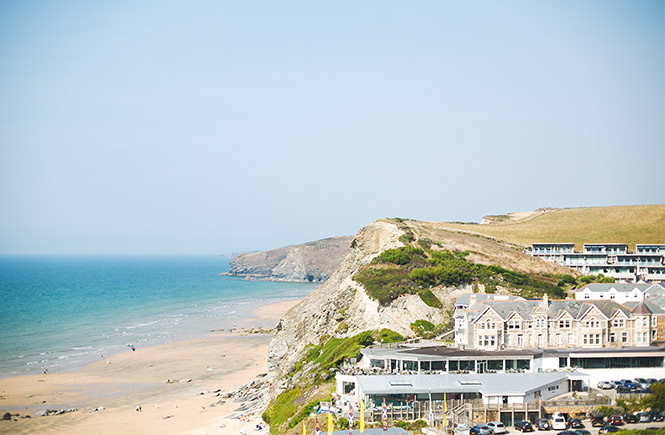 Looking out over the sandy beach, cliffs and hotel at Watergate Bay, one of the best dog-friendly beaches in Cornwall