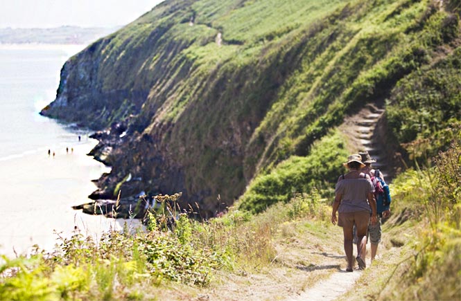 People walking along the coast path at Carbis Bay near St Ives