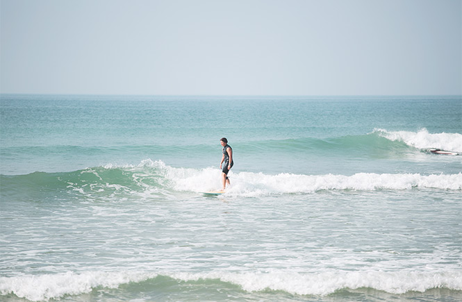 Someone surfing at Fistral Beach in Cornwall