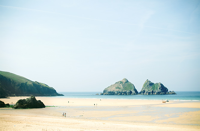 Golden sands and dramatic rock formations at Holywell Bay in Cornwall