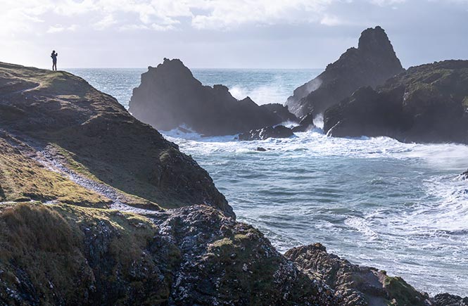 A person overlooking Kynance Cove in winter