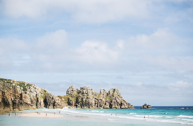 The golden sands and clear blue waters at Porthcurno beach in Cornwall