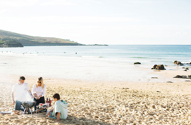 A family enjoying a bbq on Porthmeor Beach in St Ives